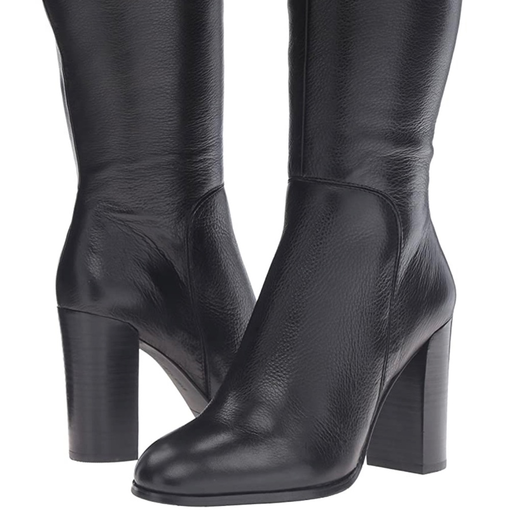 Knee-high riding boot featuring round toe and stacked block heel.
